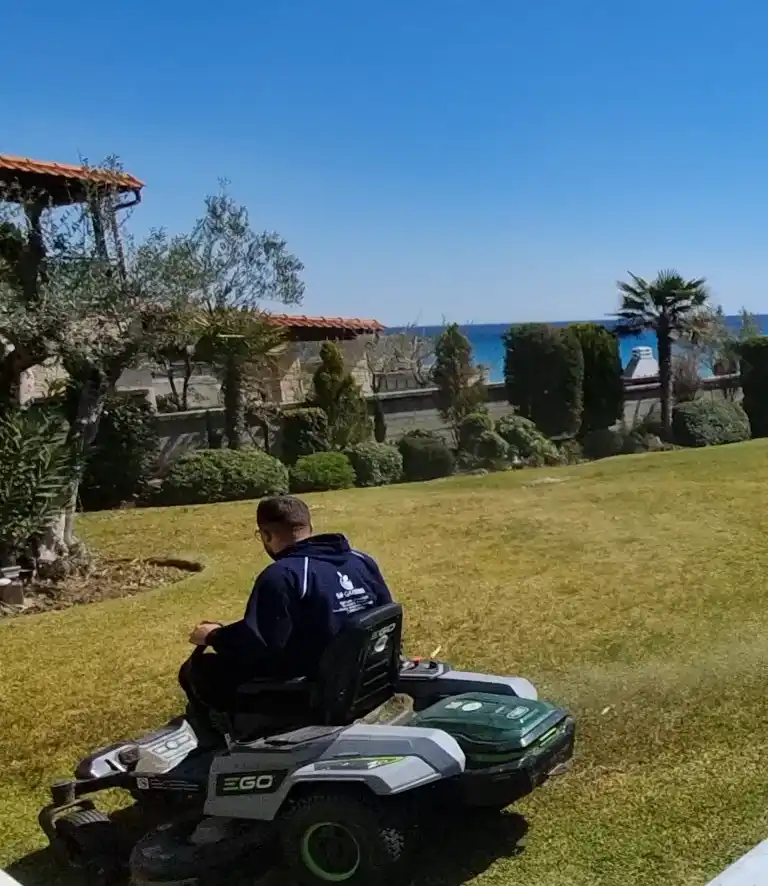 Mowing a seaside lawn with an electric ride-on mower